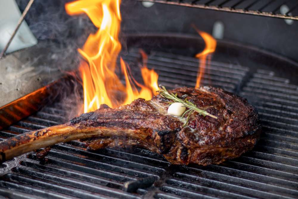 Tomahawk steak masterpiece on the grill with rosemary and butter. How to cook the perfect Tomahawk steak?