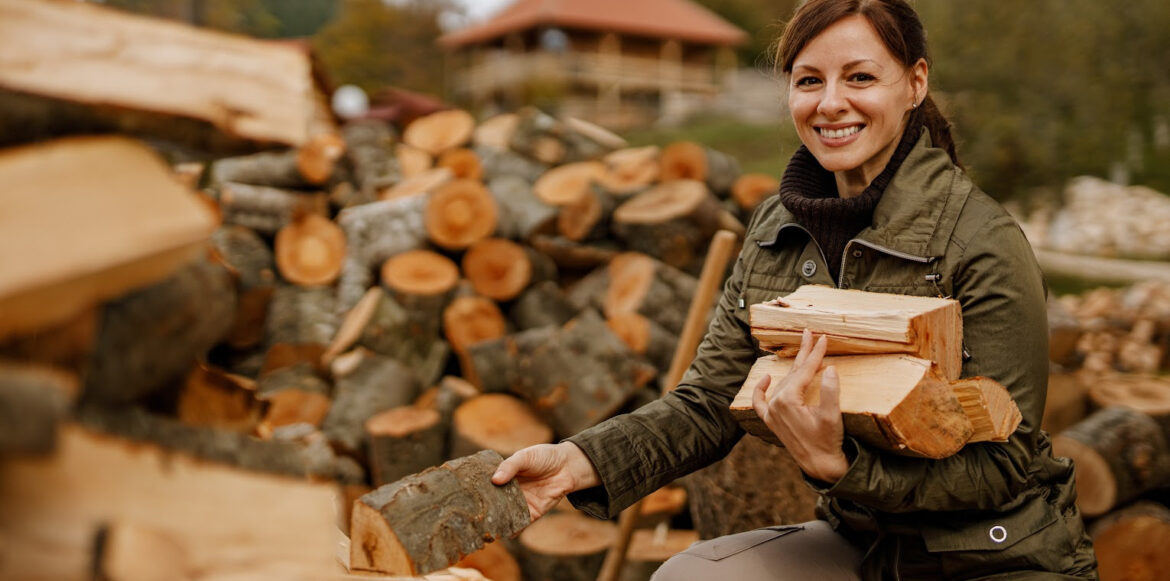 How to Stack Cord Wood - a woman is stacking wood