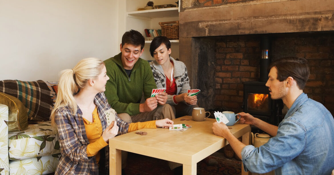 20 Cozy Fireplace Activities for Winter Enjoyment and Relaxation - friends are playing games by the fireplace