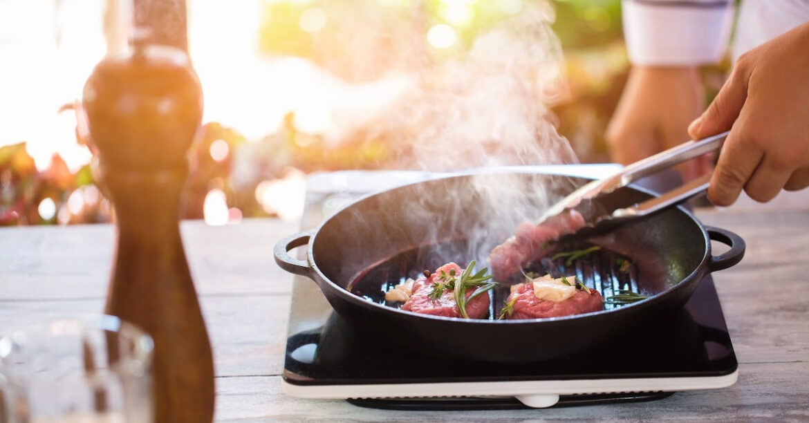 A steak is grilled in a cast iron